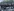 Vermummte Demonstranten in schwarzer Kleidung hinter Antifa-Transparent