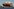 Das Containerschiff Oakland Express der Reederei SFL Corporation Ltd mit Schleppern unterwegs auf der Elbe im Hafen von Hamburg