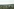 Blick über eine Mittelgebirgslandschaft mit beschaulichen Einfamilienhäuseren und einem Sendeturm