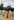 Eine Person mit Regenschirm und LGBTQ-Flagge