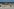 Eine Person fotografiert der toten Wal, der am Strand der dänischen Insel Anholt liegt, nachdem er aus dem Wasser gezogen wurde