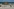Eine Person fotografiert der toten Wal, der am Strand der dänischen Insel Anholt liegt, nachdem er aus dem Wasser gezogen wurde
