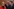 Drei Personen stehen eng zusammen und schauen ernst