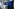 Vier Minister:innen stehen hinter jeweils einem weißen Stehpult. Hinter ihnen eine blaue Wand. Der Fotograf hat die Aufnahme von der Seite gemacht.