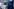 Vier Minister:innen stehen hinter jeweils einem weißen Stehpult. Hinter ihnen eine blaue Wand. Der Fotograf hat die Aufnahme von der Seite gemacht.