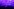 Der Sänger von Pulp - Jarvis Cocker liegt auf einer Box auf der Bühne und singt, er trägt eine Brille, Jeans und Hemd, das Licht ist purple und vernebelt