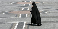 Eine Frau in einer Burka überquert den Odeonsplatz in München.