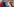 Aktivist*innen tragen Masken mit den Gesichtern von wichtigen Staatschefs und stellen sich schlafend