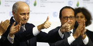 Laurent Fabius und Francois Hollande machen Siegerposen