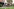 Bewohner des Seniorenheim Prenzlauer Berg im Garten - zwei sitzen im Rollstuhl, ein Mann auf der Bank.