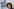 Amira Mohamed Ali, BSW-Bundesvorsitzende, steht vor einem Plakat mit der Aufschrift ?Weg mit Merz!?
