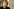 Porträt von Antje Kunstmann mit kurzen blonden Haaren, sie trägt ein schwarzes Oberteil und eine Kette mit roten Holzperlen