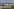 Plattenbausiedlungen grenzen am Berliner Stadtrand in Marzahn-Hellersdorf an Felder mit Windkraftanlagen