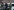 Vermummte Polizisten der Bundespolizei führen einen Mann in Handschellen ab