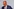 Friedrich Merz vor hellem Hintergrund mit Brille, Halbglatze und blauem Anzug mit Krawatte pustet vor sich hin - er wirkt erschöpft