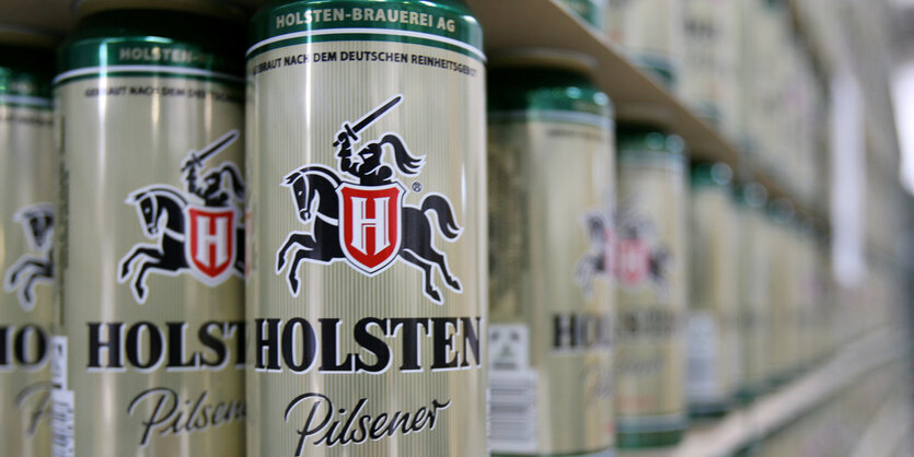 Ein Regall steht voll mit Holsten-Bierdosen.