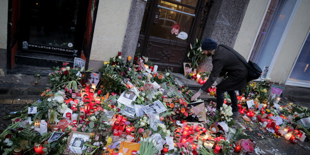 Ein Mann legt Blumen vor dem Wohnhaus nieder, in dem David Bowie in seinen Berliner Jahren lebte