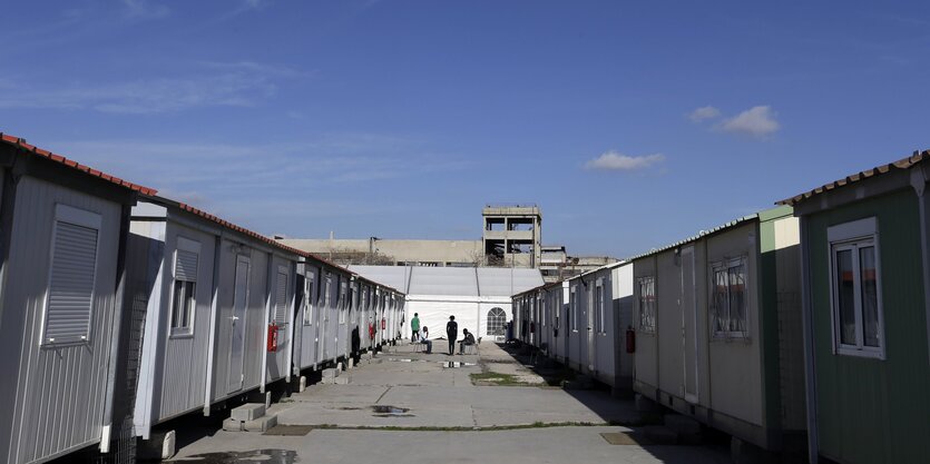 Wohncontainer rechts und links einer Betonfläche.