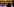 eine Silhoutte an einer Theke, vor buntem Hintergrund Alkohol Flaschen