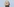 Julian Assange mit geschlossenen Augen vor blauem Himmel